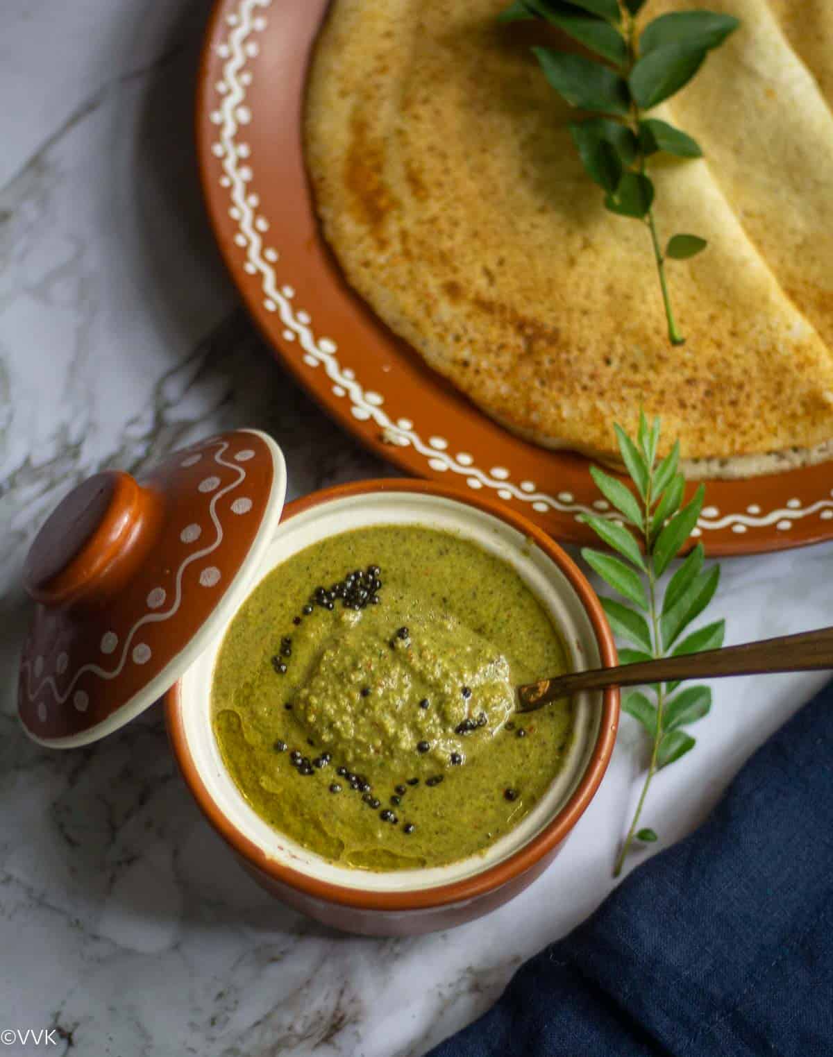 curry leaves chutney served with dosa in a terracotta serveware