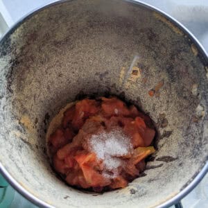 grinding the tomatoes