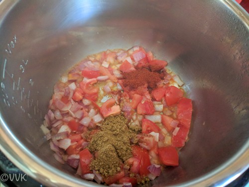 Adding red chili powder and dhaniya powder