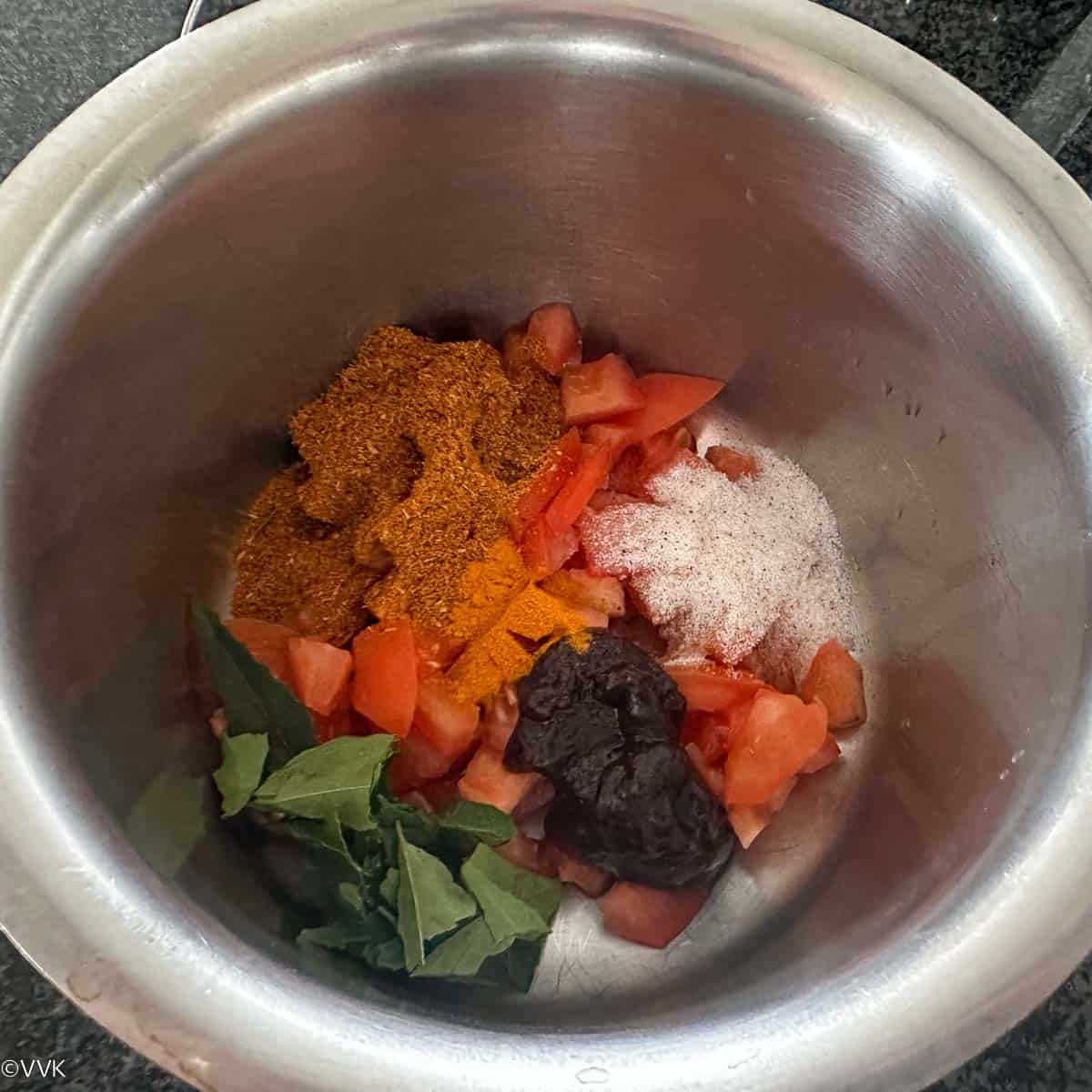 adding all the ingredients of the rasam to a bowl