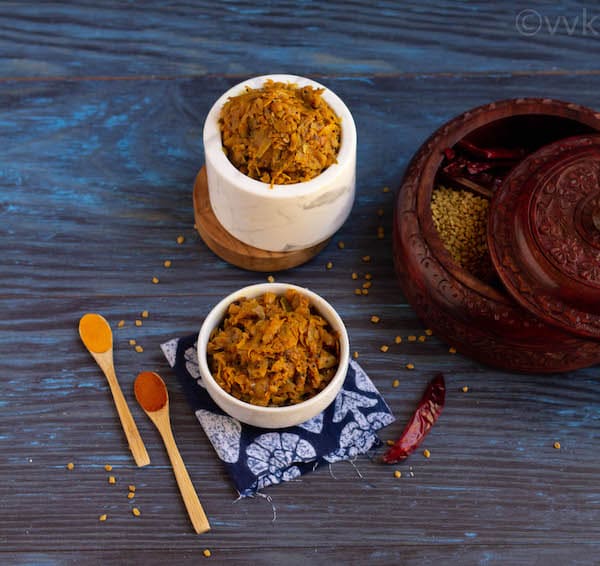 grated mango pickle in white bowls with spices on the side