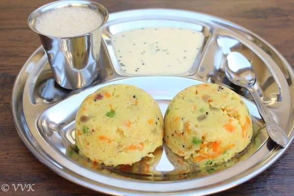 Rava Kichadi served with coconut chutney in a metal tray with a spoon on the side