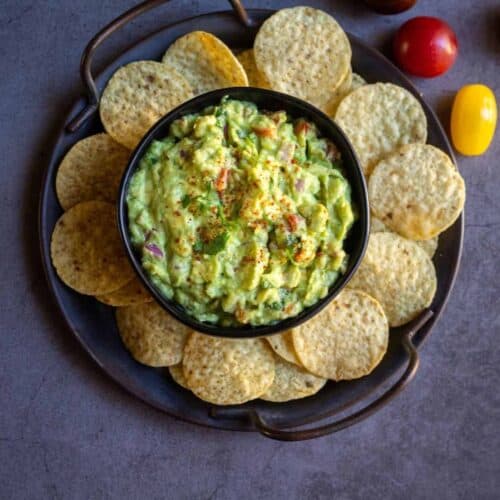overhead shot of guacamole served with chips