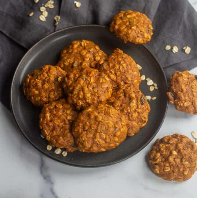 square image of vegan oatmeal cookies stacked on a plate
