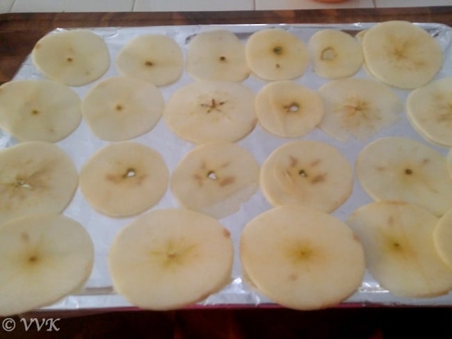 Thinly sliced apples in a tray ready for baking