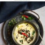 urad dal flour raita served in blackware placed on rustic tray with text overlay for pinterest
