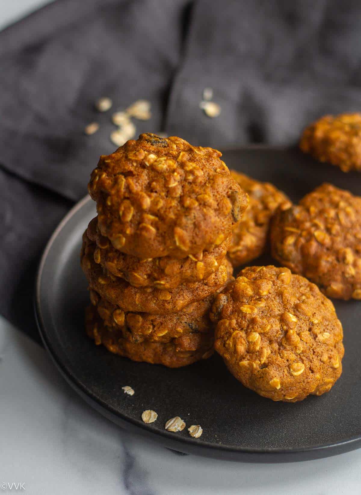 stacked up oatmeal cookies on a gray plate