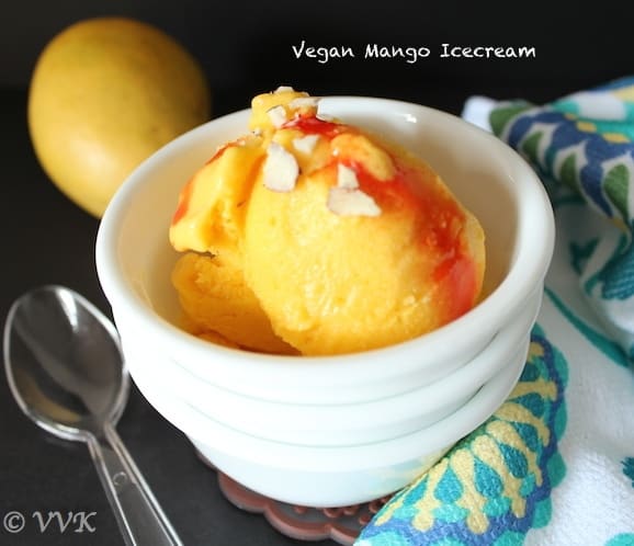 Xanthan Gum Mango Ice-Cream served in a cute little bowl with a spoon lemon right next to it