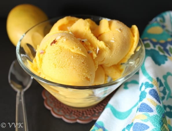 Xanthan Gum Vegan Mango Ice Cream in a bowl with a spoon on the left side of it