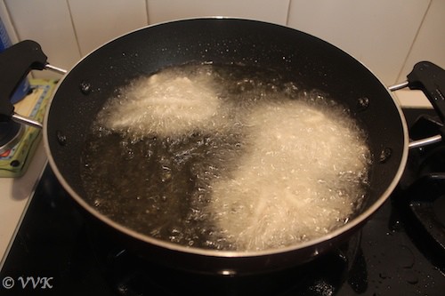 Deep frying the murukku till it turns crisps or golden brown