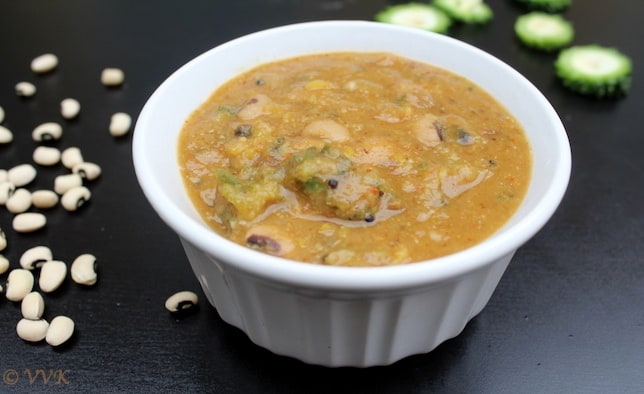 Side view of a bowl full of the delicious Pavakkai Pitlai or Bitter Gourd Black Eyed Peas Sambar