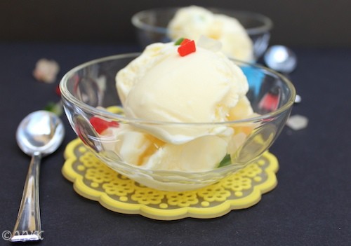 Homemade Custard Ice-Cream with Tutti Frutti closeup with a spoon next to the bowl