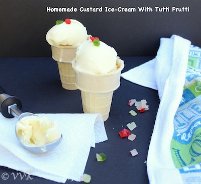 Homemade Custard Ice-Cream with Tutti Frutti covering the dark surface and a towel on the right side