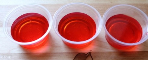 Three cups of Homemade Rose Syrup Jelly in a row