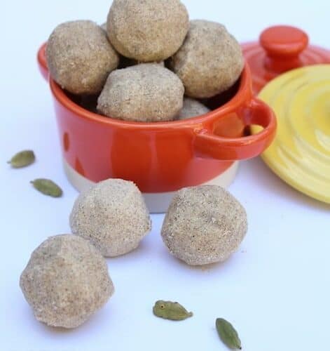 Health Mix Laddus with Ghee Residue or Sathu Maavu Urundai served in the shape of balls in a cute orange pan