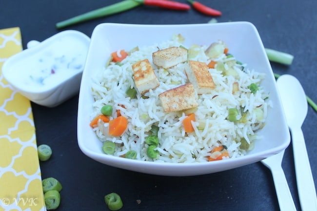 Ghee Bhath or Ghee Rice with Veggies and Paneer served with cutlery on the right side