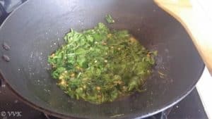 Adding the chopped spinach, salt and pepper powder and mixing well