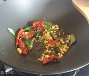 Adding mustard seeds, urad dal, channa dal, red chilies, hing and curry leaves