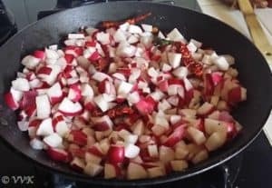 Adding the chopped red radishes