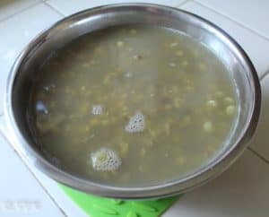 Cooling the cooked dal and setting it aside in a metal bowl