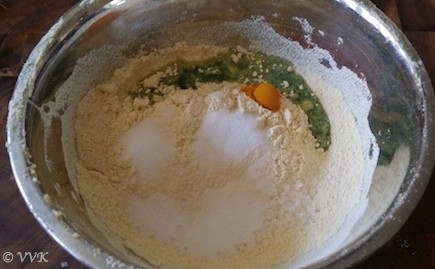 Adding the turmeric powder, ginger-cilantro-chili paste, citric acid, sugar, salt, baking soda to the besan flour