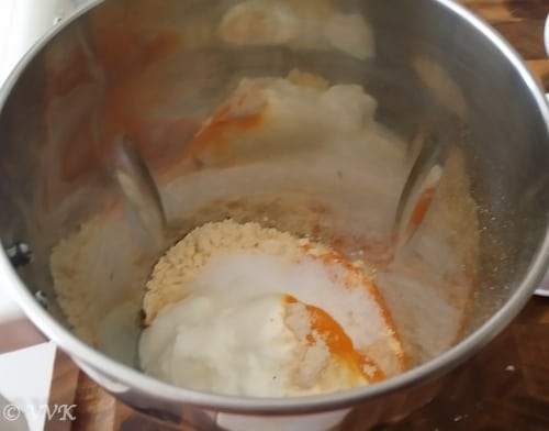 Adding the sieved besan, yogurt, hing, salt and turmeric powder to a blender