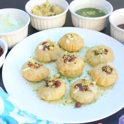Delicioous closeup of the Pani Puri or Golgappas served with many different sides around the main plate