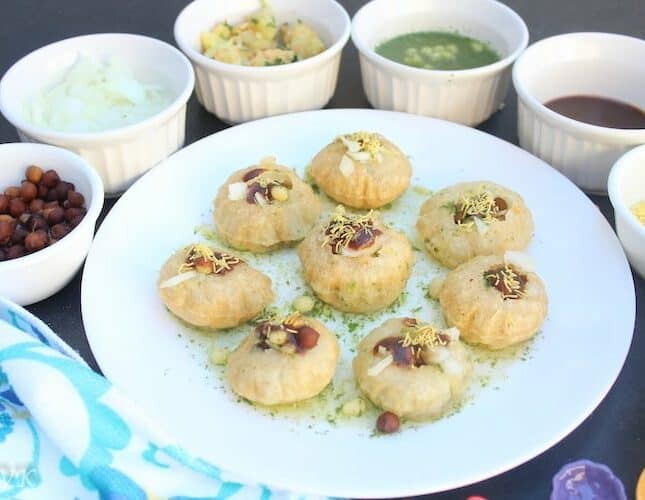 Delicioous closeup of the Pani Puri or Golgappas served with many different sides around the main plate