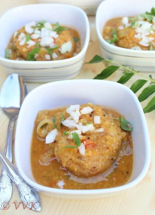 Serving Sambar Vadai in three white bowls with metal spoons on the side