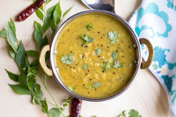 Instant Pot Amti Dal or Maharashtrian Style Dal served in a pan with peppers around it