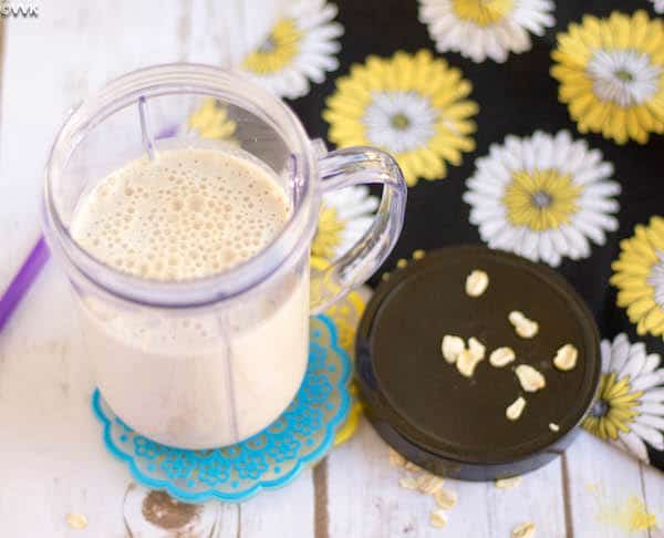 Overnight Oats and Dates Smoothie with Flax Meal served in a glass jar on a white wooden table
