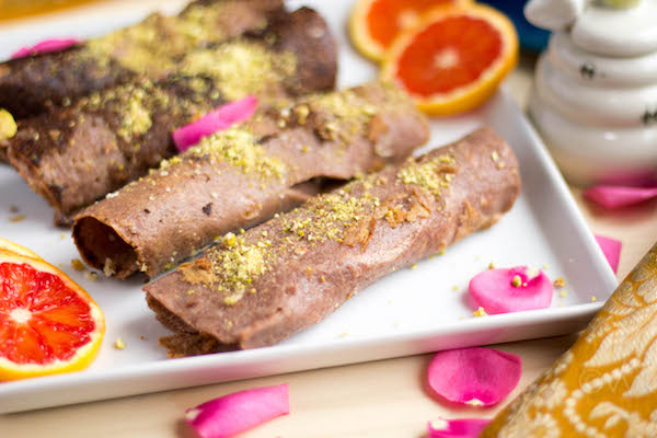 Side view of the white plate full of the delicious Ragi Malpua topped with pistachio and looking festive!