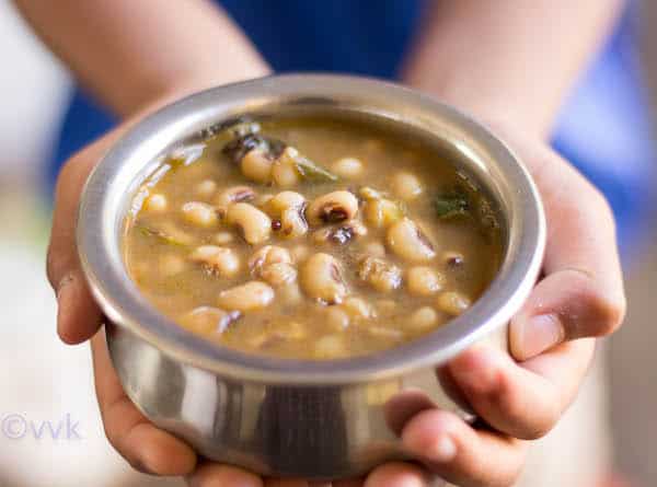 Holding a bowl of the delicious Black Eyed Peas Curry in hands