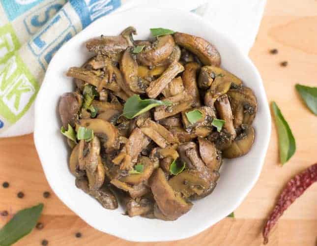 Instant Pot Mushroom Stir fry served with rice and decorated with red chilly and black pepper on a wooden table