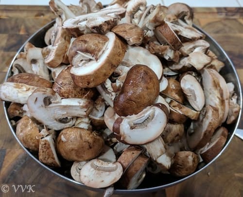 Cleaning the mushrooms with a damp cloth and chopping them