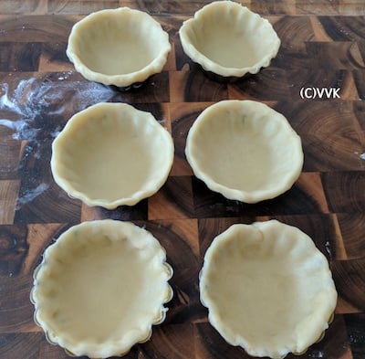 Using a cup or cookie cutter, cutting circles from the pastry