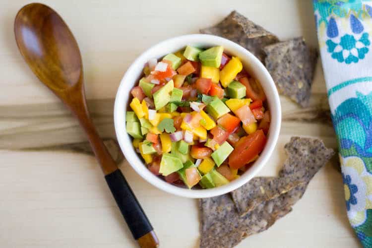 Mango Avocado Salsa Overhead on the Dish with Some Chips and a Spoon at the Side