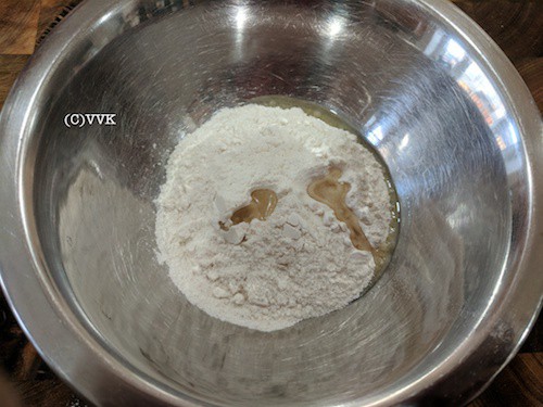 Adding dosa mix to a wide bowl