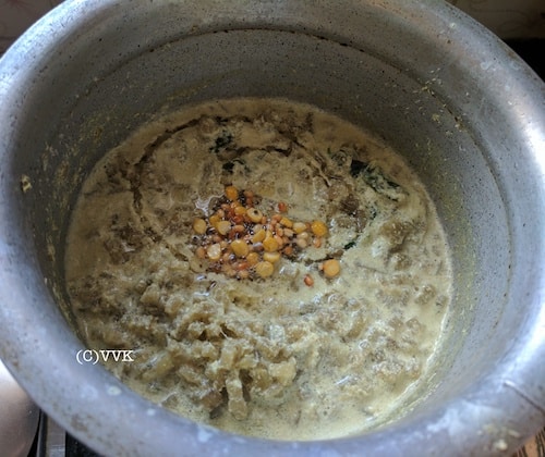 Adding mustard seeds, urad dal, and channa dal