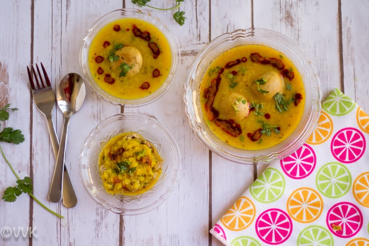 Super delicious Instant Pot Dal Bafla served in three bowls of various size with a colorful towel on the side