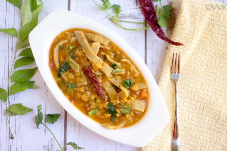 Delicious Instant Pot Rajasthani Dal Dhokli served with a fork next to the bowl