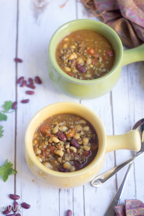 Instant Pot Kwati - Mixed Bean Stew - Side View of the Dish Served in Two Bowls with Beans and Herbs Around