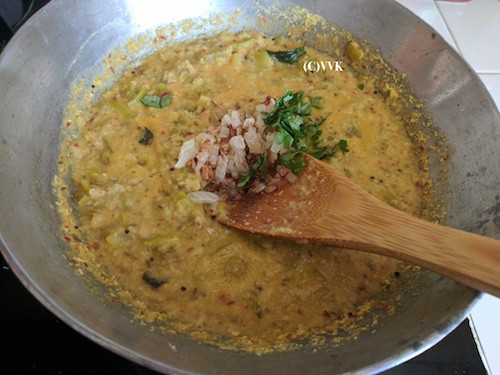 Adding onion and chopped cilantro to the kootu