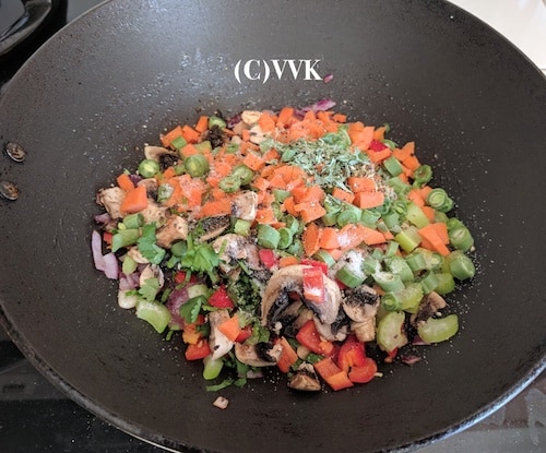 Adding chopped veggies, followed by salt, pepper, dried thyme, basil and oregano