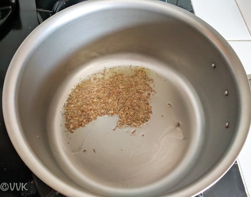 Adding the cumin seeds and letthing them crack