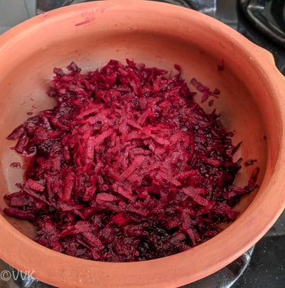 Adding grated beets and water to a pan