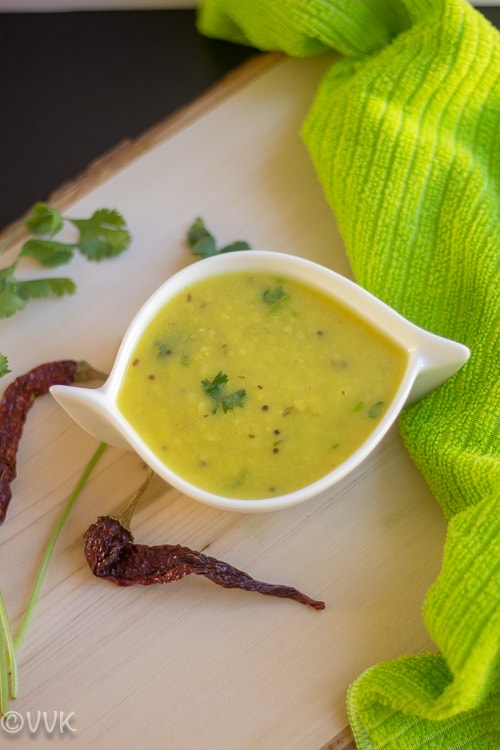 Dalithoy - Konkani Dal Recipe with chilies next to the white bowl