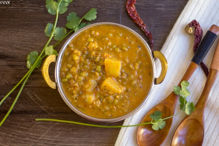 Sprouted Moong Dal Curry served with two wooden spoons on the side