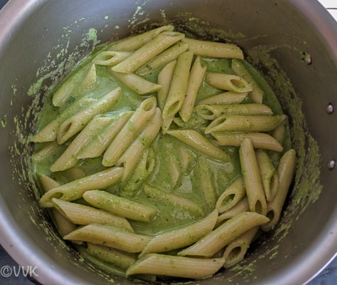Mixing pan, cooked pasta, pasta water and the prepared cilantro pesto