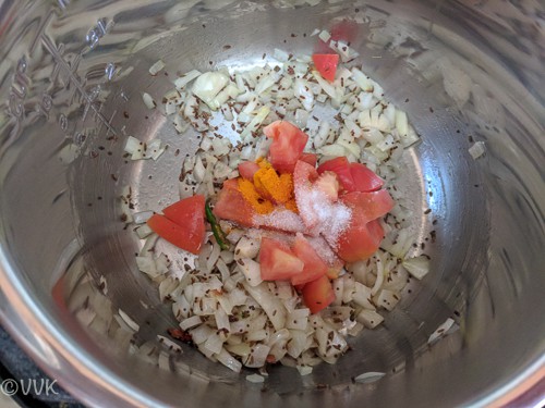 Adding chopped tomatoes, salt and turmeric